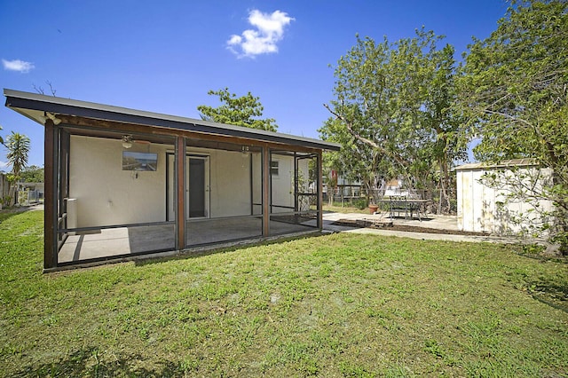 back of property with a sunroom and a patio area