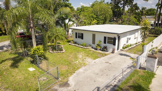 view of front of house featuring a gate, stucco siding, and driveway
