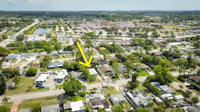 aerial view of property and surrounding area with nearby suburban area and a large body of water
