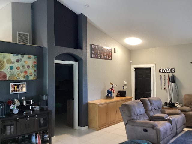 3834 SE 12th Dr, Okeechobee, FL 34974 - living room featuring vaulted ceiling and light tile patterned flooring