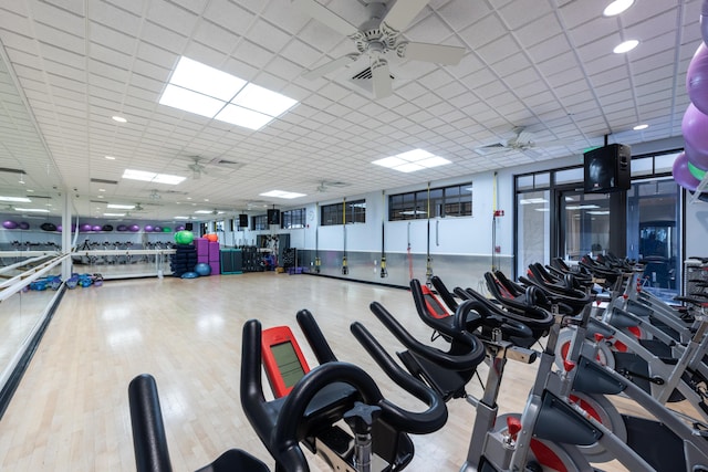 exercise room with ceiling fan and wood finished floors