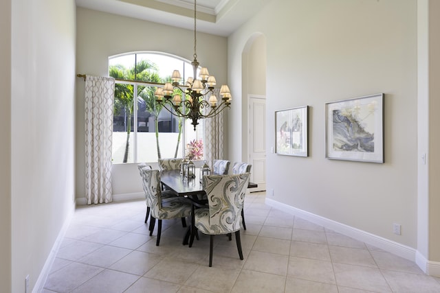 212 Montant Dr, Palm Beach Gardens, FL 33410 - tiled dining space featuring a chandelier, healthy amount of natural light, baseboards, crown molding, and arched walkways