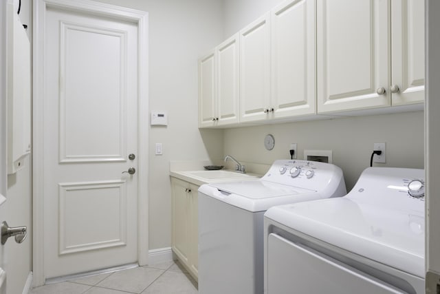 212 Montant Dr, Palm Beach Gardens, FL 33410 - washroom featuring washer and clothes dryer, cabinet space, light tile patterned floors, and baseboards