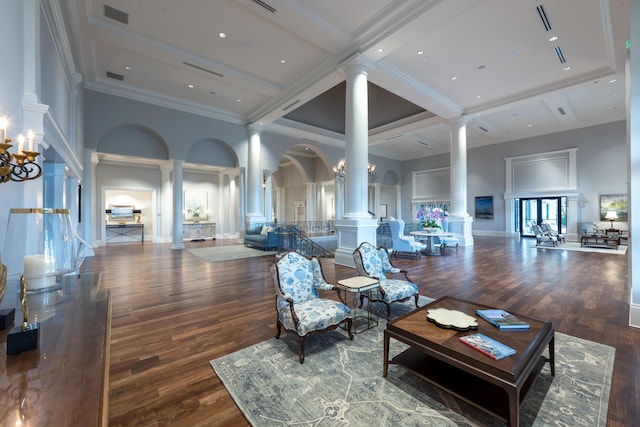 building lobby with a towering ceiling, ornamental molding, and beam ceiling