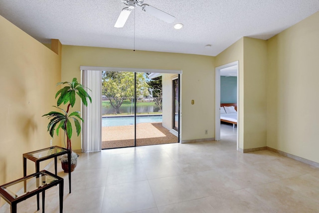 1541 SW 102nd Ter, Davie, FL 33324 - empty room with a textured ceiling, a ceiling fan, and baseboards