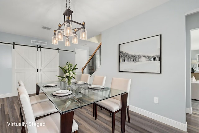 412 SW Dailey Ave, Port Saint Lucie, FL 34953 - dining space featuring wood finished floors, a barn door, and baseboards