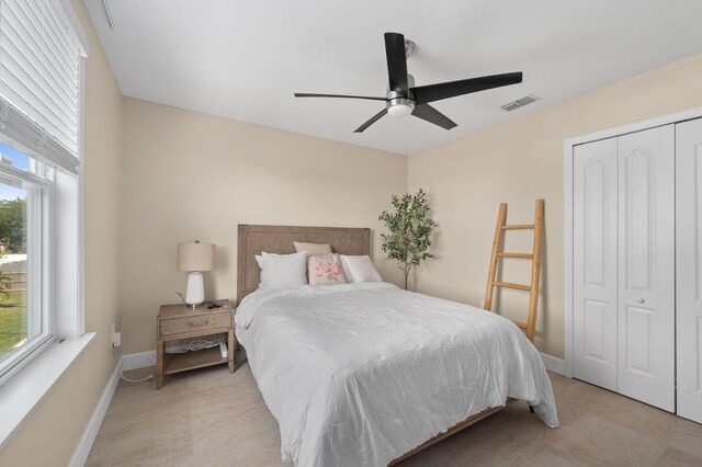 412 SW Dailey Ave, Port Saint Lucie, FL 34953 - bedroom featuring multiple windows, a closet, baseboards, and ceiling fan