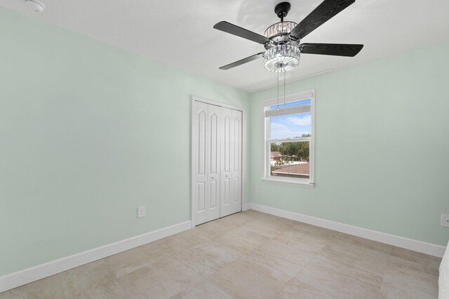 412 SW Dailey Ave, Port Saint Lucie, FL 34953 - unfurnished bedroom with baseboards, a closet, and ceiling fan