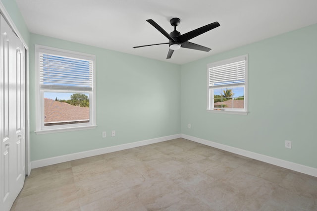 412 SW Dailey Ave, Port Saint Lucie, FL 34953 - unfurnished bedroom featuring a closet, baseboards, and a ceiling fan