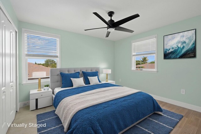 412 SW Dailey Ave, Port Saint Lucie, FL 34953 - bedroom with baseboards, wood finished floors, and a ceiling fan