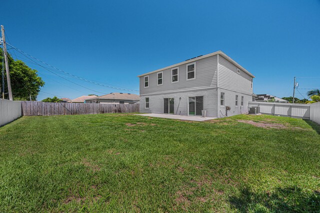 412 SW Dailey Ave, Port Saint Lucie, FL 34953 - back of property with central AC and a patio area