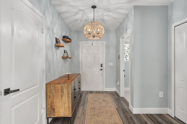 412 SW Dailey Ave, Port Saint Lucie, FL 34953 - foyer entrance featuring a chandelier, dark wood-style flooring, and baseboards