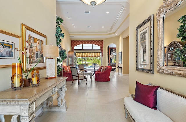 7731 Blue Heron Way, West Palm Beach, FL 33412 - corridor featuring arched walkways, a towering ceiling, a raised ceiling, light tile patterned floors, and recessed lighting