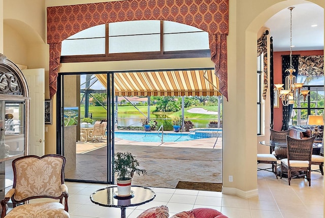 7731 Blue Heron Way, West Palm Beach, FL 33412 - interior space with arched walkways, healthy amount of natural light, tile patterned flooring, and baseboards