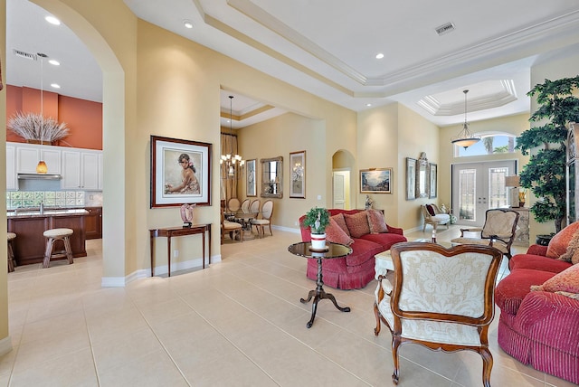 7731 Blue Heron Way, West Palm Beach, FL 33412 - living area featuring arched walkways, a high ceiling, a tray ceiling, light tile patterned flooring, and recessed lighting