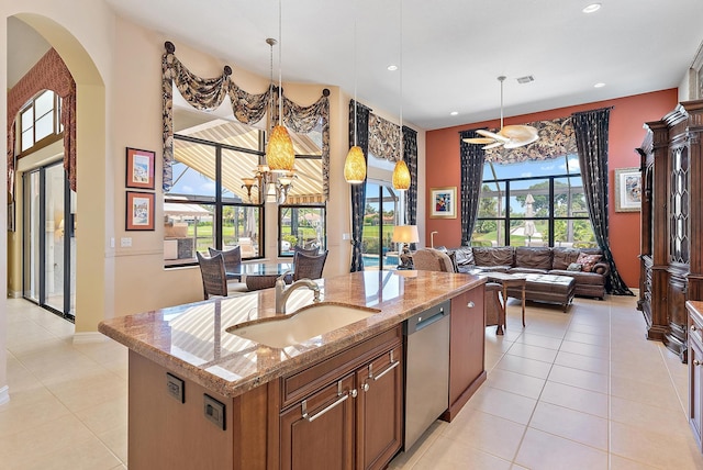 7731 Blue Heron Way, West Palm Beach, FL 33412 - kitchen with a sink, stainless steel dishwasher, light tile patterned flooring, arched walkways, and a chandelier
