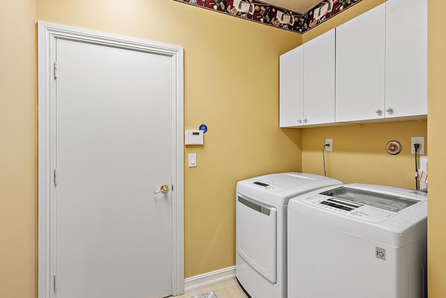 7731 Blue Heron Way, West Palm Beach, FL 33412 - laundry room with cabinet space, separate washer and dryer, baseboards, and light tile patterned flooring