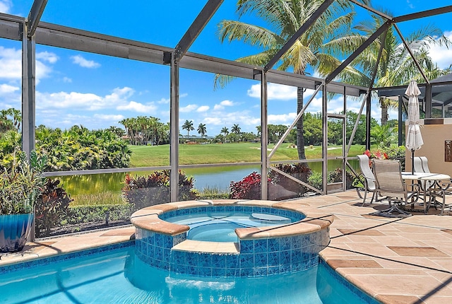 7731 Blue Heron Way, West Palm Beach, FL 33412 - view of swimming pool featuring glass enclosure, a patio area, a pool with connected hot tub, and a water view