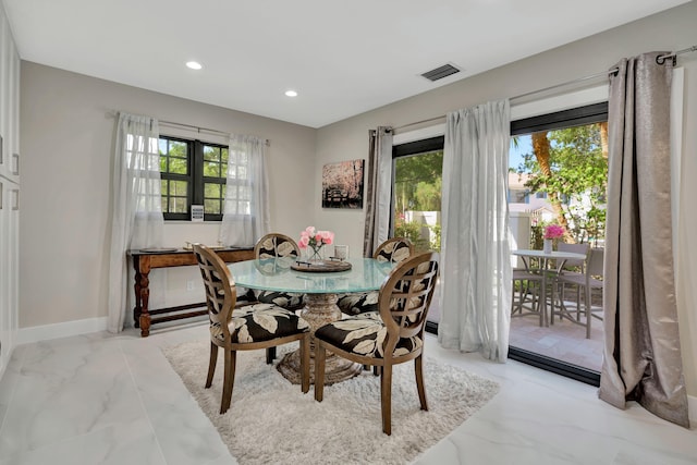 dining area with recessed lighting, light marble finish flooring, and baseboards