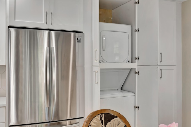 washroom featuring stacked washing machine and dryer