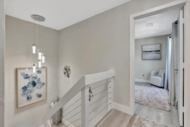 stairs with wood finished floors and baseboards