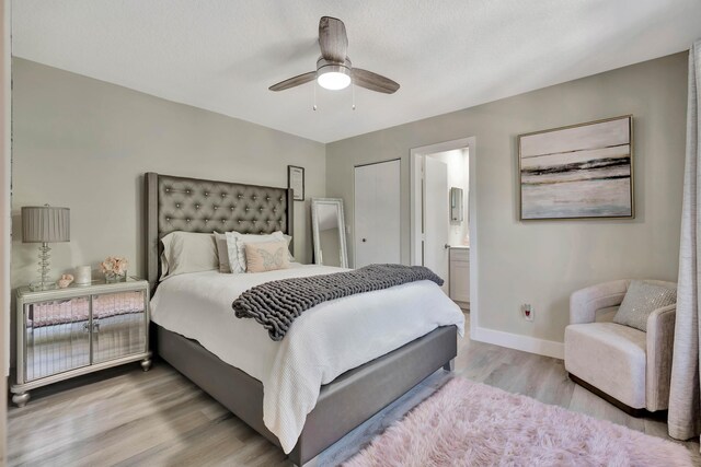 bedroom featuring wood finished floors, baseboards, connected bathroom, and ceiling fan
