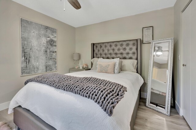 bedroom with wood finished floors, baseboards, and ceiling fan