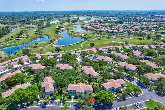 aerial overview of property's location featuring nearby suburban area, a golf club, and a large body of water