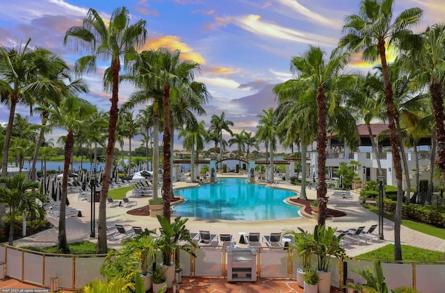 community pool featuring a water view and a patio