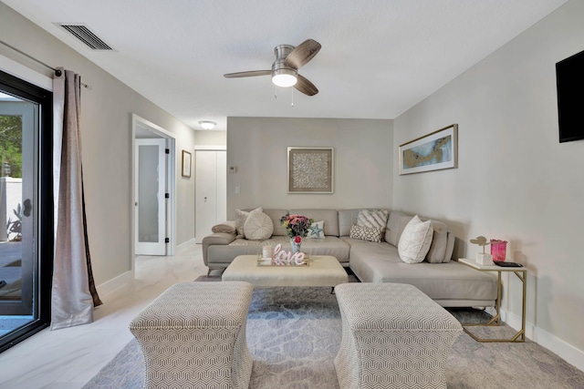 living room featuring ceiling fan and baseboards