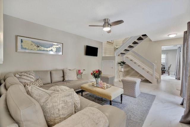 living room featuring stairs and a ceiling fan