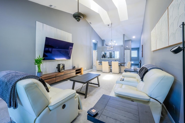 living area featuring carpet floors, a chandelier, a skylight, high vaulted ceiling, and baseboards