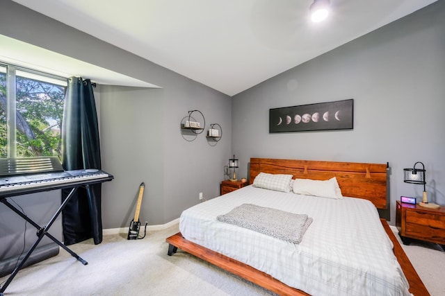 carpeted bedroom with lofted ceiling and baseboards