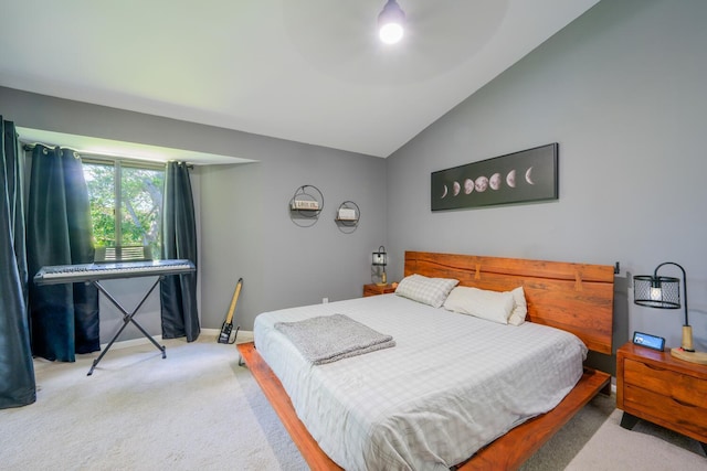 bedroom featuring carpet flooring, lofted ceiling, and baseboards