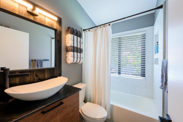 bathroom featuring toilet, vanity, and shower / tub combo with curtain