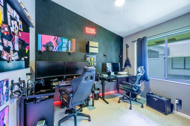 carpeted home office featuring vaulted ceiling and baseboards