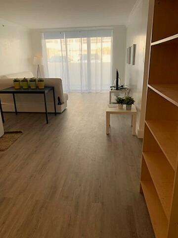 3001 S Ocean Dr S Unit 101, Hollywood, FL 33019 - living area featuring wood finished floors and plenty of natural light