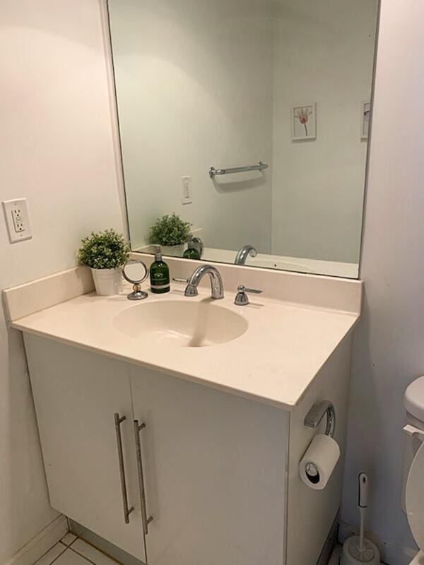 3001 S Ocean Dr S Unit 101, Hollywood, FL 33019 - half bath featuring toilet, vanity, and tile patterned floors