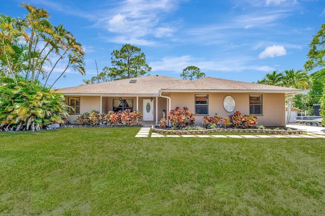 16888 W Downers Dr W, The Acreage, FL 33470 - ranch-style home featuring a front yard and stucco siding