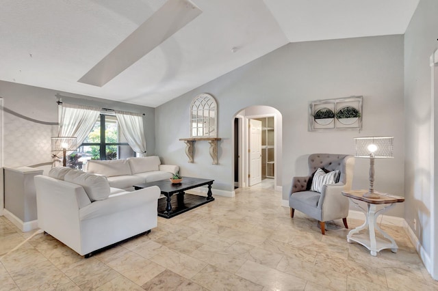 16888 W Downers Dr W, The Acreage, FL 33470 - living room with arched walkways, vaulted ceiling, light marble finish floors, and baseboards