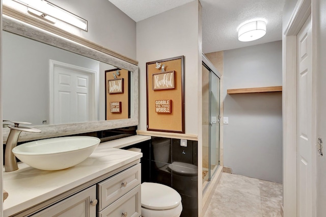 16888 W Downers Dr W, The Acreage, FL 33470 - full bath featuring toilet, a shower stall, vanity, and a textured ceiling