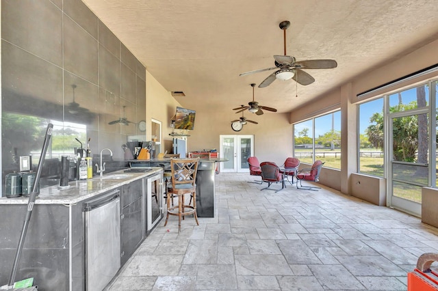 16888 W Downers Dr W, The Acreage, FL 33470 - view of patio / terrace with french doors, a ceiling fan, an outdoor bar, exterior kitchen, and wine cooler
