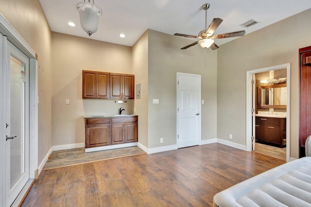 16888 W Downers Dr W, The Acreage, FL 33470 - bar area with wood finished floors, baseboards, ceiling fan, a sink, and a towering ceiling