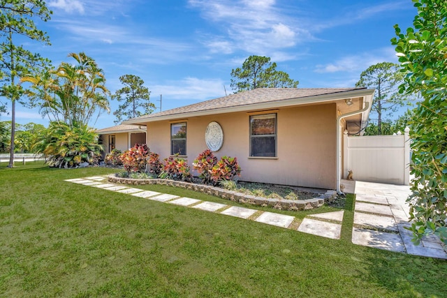 16888 W Downers Dr W, The Acreage, FL 33470 - view of front of property with stucco siding and a shingled roof