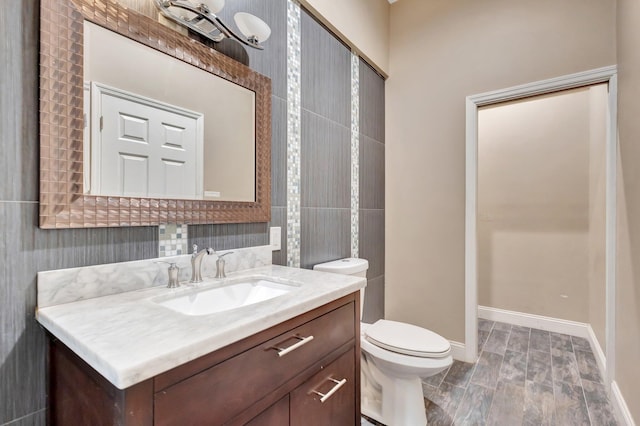 16888 W Downers Dr W, The Acreage, FL 33470 - bathroom featuring toilet, vanity, and baseboards