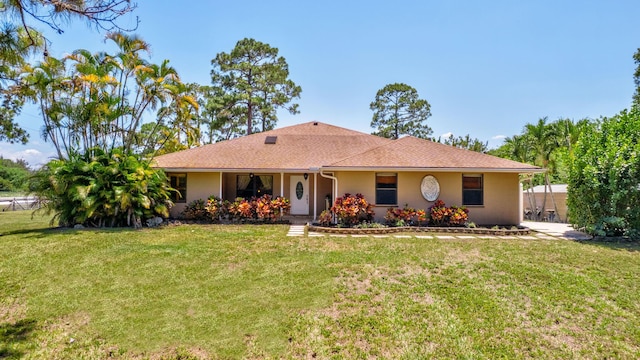 16888 W Downers Dr W, The Acreage, FL 33470 - ranch-style home featuring a front yard and stucco siding