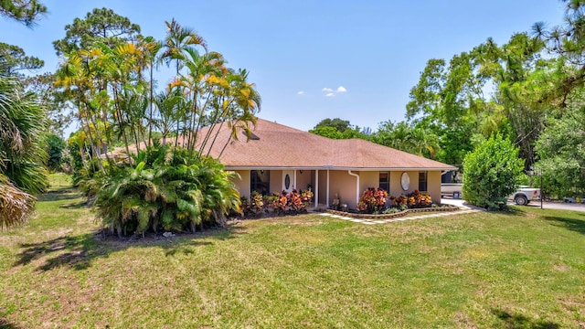 16888 W Downers Dr W, The Acreage, FL 33470 - ranch-style home with a front lawn and stucco siding