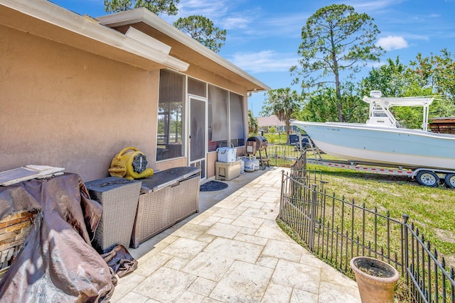 16888 W Downers Dr W, The Acreage, FL 33470 - view of patio / terrace with a sunroom and fence