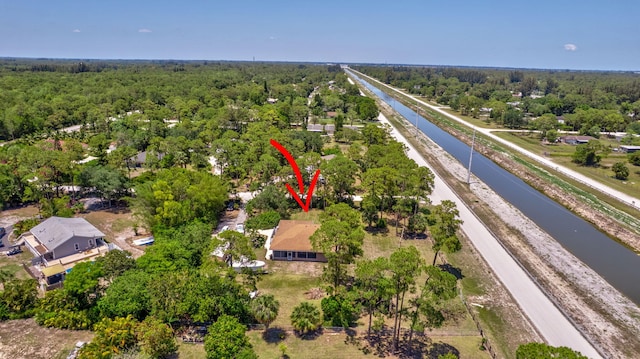 16888 W Downers Dr W, The Acreage, FL 33470 - drone / aerial view of a nearby body of water and a heavily wooded area