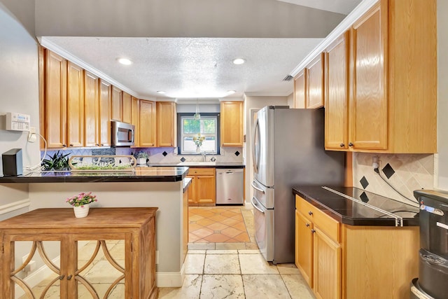 16888 W Downers Dr W, The Acreage, FL 33470 - kitchen with stainless steel appliances, a peninsula, backsplash, dark countertops, and a kitchen bar